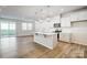 Open kitchen concept featuring an island, pendant lighting, stainless steel appliances, and wood-look flooring at 2340 Hedgecliff Rd # 156, Kannapolis, NC 28025