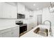 The kitchen is equipped with stainless steel appliances, white cabinets, and a quartz countertop at 2340 Hedgecliff Rd # 156, Kannapolis, NC 28025