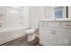 Bathroom boasts white cabinetry, vinyl flooring, and shower and tub combo at 2350 Hedgecliff Rd, Kannapolis, NC 28025