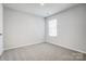 Bedroom featuring plush carpets, neutral walls, and window with window blinds at 2350 Hedgecliff Rd, Kannapolis, NC 28025