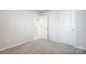 Bright bedroom with plush carpets, neutral walls, and access to closet and hallway at 2350 Hedgecliff Rd, Kannapolis, NC 28025
