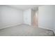 Carpeted bedroom offers neutral walls and a double door closet and hallway access at 2350 Hedgecliff Rd, Kannapolis, NC 28025