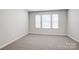 Bedroom with three windows providing natural light and plush carpeted floors at 2350 Hedgecliff Rd, Kannapolis, NC 28025