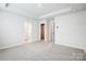 Bright bedroom boasts neutral walls, plush carpeting, and access to bathroom and closet at 2350 Hedgecliff Rd, Kannapolis, NC 28025
