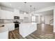 Well-lit kitchen with stainless steel appliances, white cabinets, and a central island, offering ample prep space at 2350 Hedgecliff Rd, Kannapolis, NC 28025