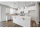 Modern kitchen features white cabinets, stainless steel appliances, an island, and stylish pendant lighting at 2350 Hedgecliff Rd, Kannapolis, NC 28025