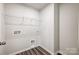 Laundry room featuring vinyl floors, hookups for washer and dryer, and wire shelves at 2350 Hedgecliff Rd, Kannapolis, NC 28025