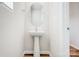 Stylish powder room with pedestal sink, oval mirror, and neutral paint at 2350 Hedgecliff Rd, Kannapolis, NC 28025