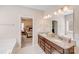 Bright bathroom with a double vanity, granite countertops, and access to the main bedroom at 245 Pine Eagle Dr, Rock Hill, SC 29732