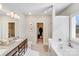 Bright bathroom featuring double vanity with granite countertop, soaking tub, and walk-in closet at 245 Pine Eagle Dr, Rock Hill, SC 29732