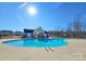 Community pool with a sun deck, covered seating area, and a clear blue sky at 245 Pine Eagle Dr, Rock Hill, SC 29732