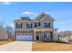 Charming two-story home with a stone and siding facade, a two-car garage, and a well-maintained front lawn at 245 Pine Eagle Dr, Rock Hill, SC 29732