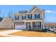 Charming two-story home with a stone and siding facade, a two-car garage, and a well-maintained front lawn at 245 Pine Eagle Dr, Rock Hill, SC 29732