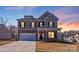 Charming two-story home with a stone and siding facade, a two-car garage, and a well-maintained front lawn at 245 Pine Eagle Dr, Rock Hill, SC 29732
