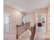 Upstairs hallway with carpeted floor and wooden bannister, with multiple bedrooms at 245 Pine Eagle Dr, Rock Hill, SC 29732