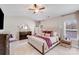 Bright main bedroom featuring soft carpet, a large window, and a dresser with a round mirror at 245 Pine Eagle Dr, Rock Hill, SC 29732