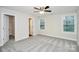 Spacious bedroom with two windows, carpet floors, and ceiling fan at 265 Duke Dr, Salisbury, NC 28146