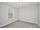A bright bedroom features neutral paint, carpet, a window, and a modern ceiling light at 265 Duke Dr, Salisbury, NC 28146