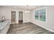 Bright dining room with grey wood-look flooring, neutral paint, and a view to the kitchen at 265 Duke Dr, Salisbury, NC 28146