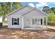 Charming single-story home with light gray siding, black shutters, and a cozy covered front porch at 265 Duke Dr, Salisbury, NC 28146