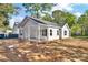 Single-story home with gray siding, black shutters, and inviting covered front porch and yard at 265 Duke Dr, Salisbury, NC 28146