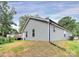A gray-sided one-story home is pictured in front of a grassy lawn and blue skies at 265 Duke Dr, Salisbury, NC 28146
