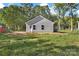 View of a new home from the backyard on a large lot surrounded by tall, mature trees at 265 Duke Dr, Salisbury, NC 28146
