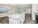 Kitchen island with granite countertops, stainless appliances, and gray wood floors at 265 Duke Dr, Salisbury, NC 28146
