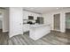 Kitchen with white cabinetry, stainless steel appliances, gray wood floors, and granite countertops at 265 Duke Dr, Salisbury, NC 28146