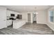 Bright modern kitchen with white cabinets, stainless steel appliances, granite countertops and grey wood-look floors at 265 Duke Dr, Salisbury, NC 28146