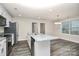 Spacious kitchen with an island, granite countertops, stainless steel appliances and gray wood floors at 265 Duke Dr, Salisbury, NC 28146
