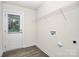 Bright laundry room with a back door, wire shelving, and hookups for a washer and dryer at 265 Duke Dr, Salisbury, NC 28146