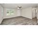 Bright living room featuring grey wood-look flooring and a large window overlooking the front yard at 265 Duke Dr, Salisbury, NC 28146