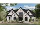 Beautiful exterior elevation featuring white painted brick, black trim, and landscaped yard at 310 Sugar Maple Ln, Weddington, NC 28104