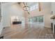 Open-concept with hardwood floors, fireplace, and sliding doors to screened porch at 310 Sugar Maple Ln, Weddington, NC 28104