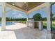 Outdoor kitchen with grill and stone accents, overlooking the pool and backyard at 310 Sugar Maple Ln, Weddington, NC 28104