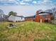 Spacious backyard features green grass, a fire pit, and a view of the home's exterior at 337 Glenwood Dr, Mooresville, NC 28115