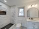 Modern bathroom features a tiled walk-in shower, vanity and gold-framed mirror at 337 Glenwood Dr, Mooresville, NC 28115