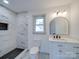 Bright bathroom features a vanity, toilet and tiled shower with niche at 337 Glenwood Dr, Mooresville, NC 28115
