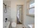 Bright bathroom features modern fixtures, including a rainfall shower head and marble tiling throughout at 337 Glenwood Dr, Mooresville, NC 28115