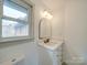 Bathroom features a vanity and arched mirror and window for natural light at 337 Glenwood Dr, Mooresville, NC 28115