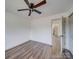 Neutral bedroom with wood floors, overhead ceiling fan and a doorway leading into the home at 337 Glenwood Dr, Mooresville, NC 28115