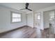 Bedroom with hardwood floors, ceiling fan, closet and view to bathroom and kitchen at 337 Glenwood Dr, Mooresville, NC 28115