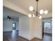 Open-concept dining area with modern chandelier, and easy access to kitchen and living room at 337 Glenwood Dr, Mooresville, NC 28115