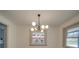 Dining room with modern chandelier and a window overlooking the front yard at 337 Glenwood Dr, Mooresville, NC 28115