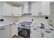 Modern kitchen features white cabinets, marble countertops, subway tile backsplash, and stainless steel appliances at 337 Glenwood Dr, Mooresville, NC 28115