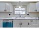 Kitchen features white cabinets, granite countertops, stainless appliances and tiled backsplash at 337 Glenwood Dr, Mooresville, NC 28115