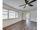 Bright living room featuring hardwood floors, a ceiling fan, and plenty of natural light at 337 Glenwood Dr, Mooresville, NC 28115