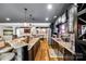 A well-equipped bar with stone accents and modern appliances is ready for entertaining in the basement at 341 Fischer Rd, Fort Mill, SC 29715