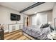 Bright bedroom showcasing wood floors, a sleek dresser with a TV, and a comfortable bed at 341 Fischer Rd, Fort Mill, SC 29715